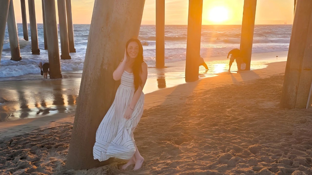 Kay under the pier at sunset