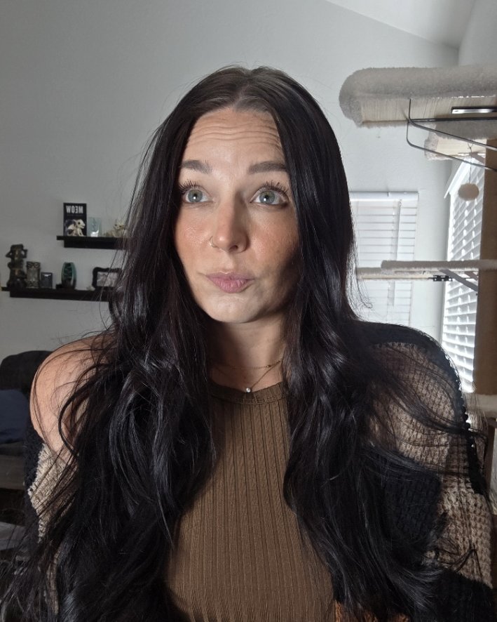 My hair now — long, dark, full after a year of the routine