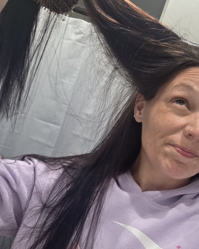 Brushing out my hair, short new growth visible at the roots