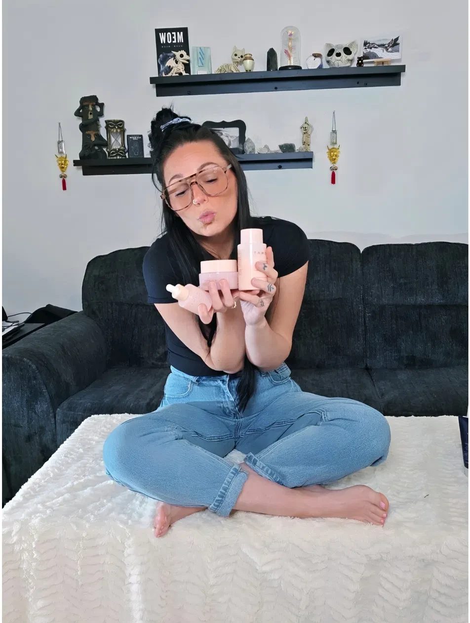 Kay holding the three MONAT Barrier Booster products — toner, niacinamide serum, and moisturizer